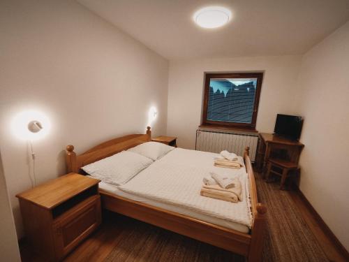 a bedroom with a bed with towels on it at Rooms and Apartments Panker in Moravske Toplice
