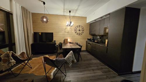 a kitchen with a table and chairs in a room at LuxLapland Cranberry Levi in Levi