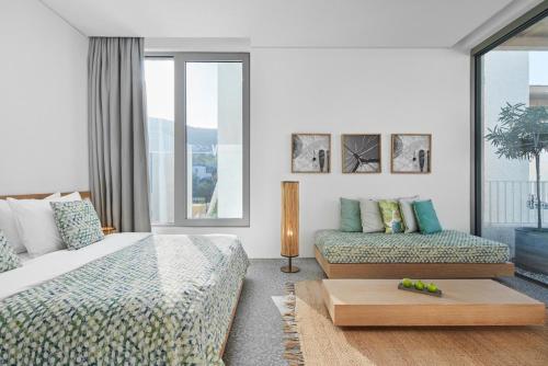a bedroom with two beds and a couch at Voyage Torba Hotel in Torba