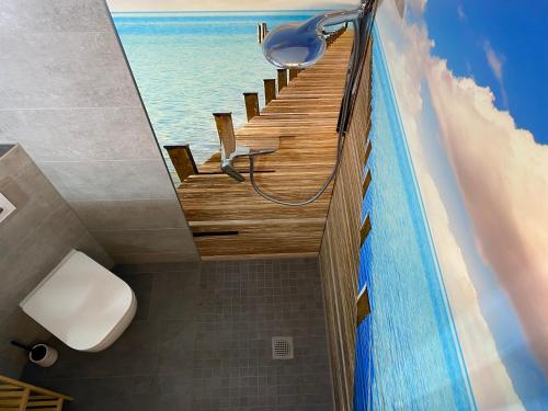 a bathroom with a stairway to the ocean on the wall at Ferienwohnung Blaues Haus in Schmalkalden