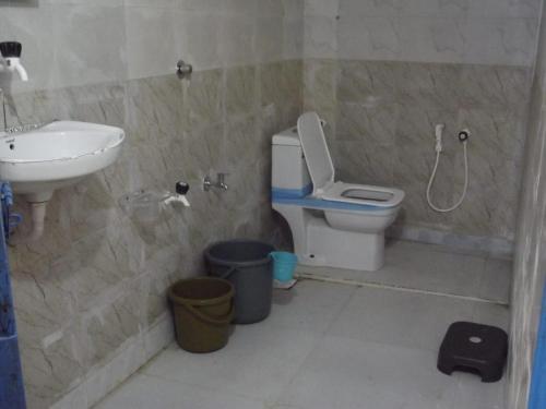 a bathroom with a toilet and a sink at Rann Kutch Resort in Dhordo