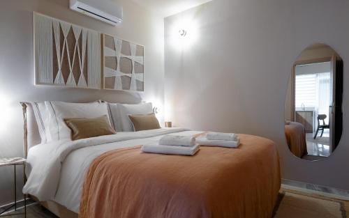 a bedroom with a large bed with two towels on it at Numa Suites & Lofts Athens in Athens