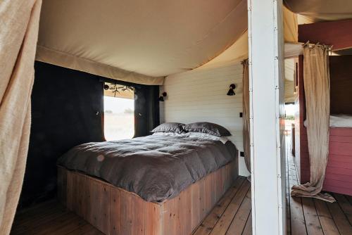 a bed in a room in a tent at Finest Retreats - Foxley Lodge in Little Walsingham