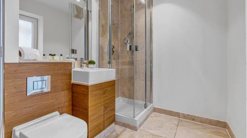 a bathroom with a sink and a shower at Modern apartments close to Colombia Road Market in London