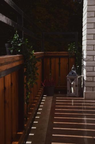 a patio with potted plants on a wooden fence at Rooms and Apartments Panker in Moravske Toplice