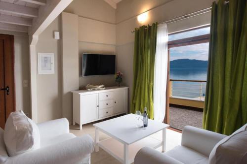 a living room with a view of the ocean at NV Suites Nikiana Lefkada AV Properties in Nikiana