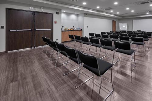 a conference room with chairs and a podium in the background at City Express by Marriott Monterrey Lindavista in Monterrey