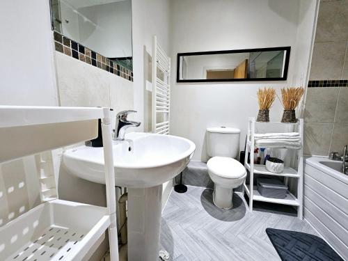 a white bathroom with a sink and a toilet at Central Location in London