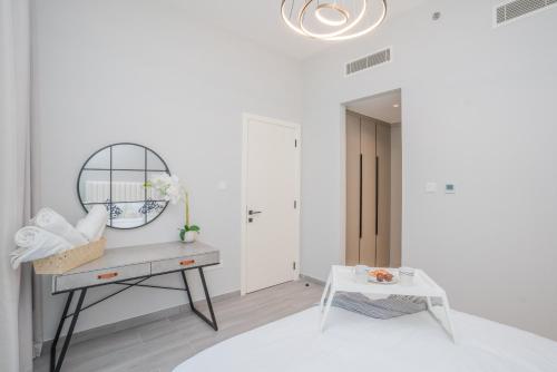 a white room with a dressing table and a mirror at Tamm - Noor 4 Tower in Dubai