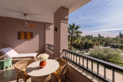 a balcony with a table and chairs and a view at Four Seasons Resort Marrakech in Marrakech