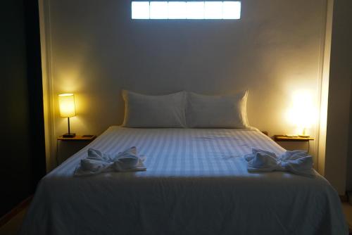 a bedroom with a bed with two shoes on it at House Bok Bowie in Koh Rong Sanloem