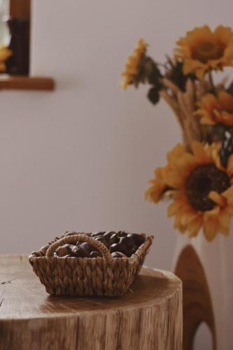 a basket of rocks sitting on a table with a vase at Rooms and Apartments Panker in Moravske Toplice