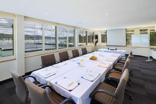 a large meeting room with a large table and chairs at Mirage Hotel Newport in Newport