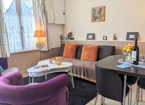 un salon avec un canapé et une table dans l'établissement Maison de pêcheur Souffle de Mer, à Saint-Valery-sur-Somme