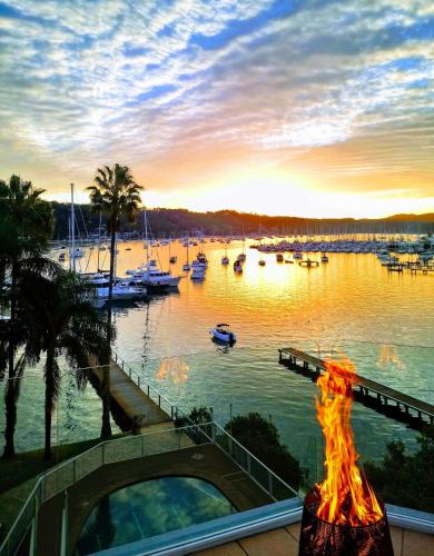 a fire burns in front of a marina with boats at Mirage Hotel Newport in Newport
