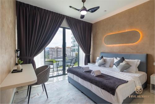 a bedroom with a bed and a desk and a balcony at Datum Jelatek Residence, KLCC in Kuala Lumpur