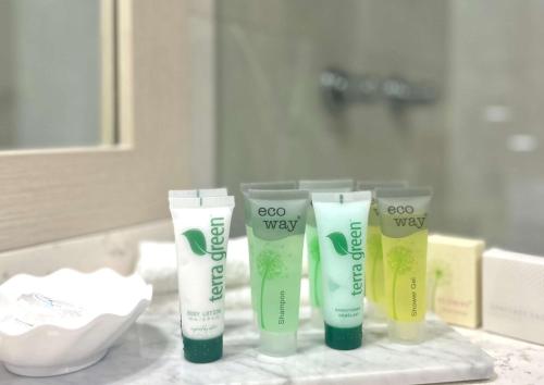 eine Gruppe von vier Produkten, die auf einer Badezimmertheke sitzen in der Unterkunft Metro Aspire Hotel Sydney in Sydney