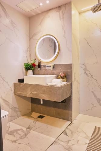 a bathroom with a sink and a mirror at THE PARK GATE in Mohali