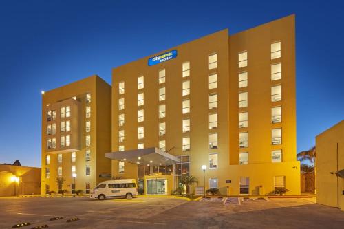 a building with a van parked in front of it at City Express by Marriott Matamoros in Matamoros
