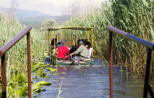 a group of people sitting on a boat in the water at Hotel Storia in Čapljina