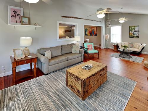 a living room with a couch and a coffee table at Nautical Watch in Tybee Island