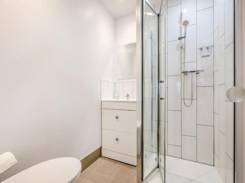 a bathroom with a shower and a toilet at Hide On The Hill in Theale