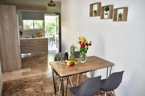 a table with a vase of flowers and fruit on it at Anastasia mare home #A# in Rethymno