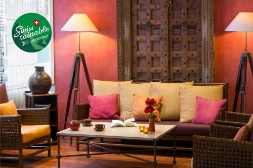 a living room with a couch and a table at Kipling Manotel in Geneva