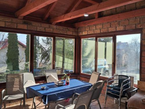 a dining room with a blue table and chairs at VILLA ORYX free double garage parking in Sarajevo