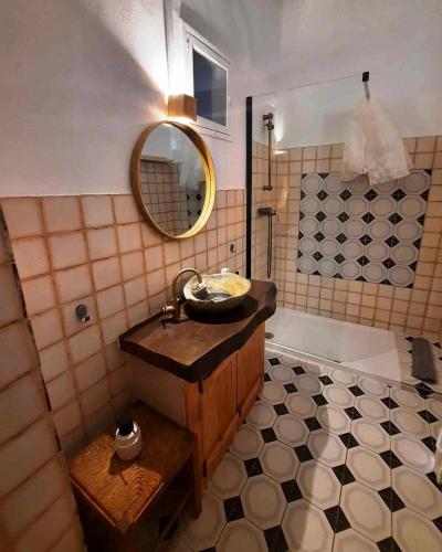 a bathroom with a sink and a tub with a mirror at Casa Malva - Traditional townhouse apartment in Monchique