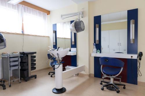 a dental room with a sink and a mirror at ÖJAB Waldpension 