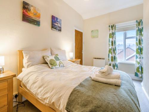 a bedroom with a large bed with a window at Cobblers Flat in Llanidloes