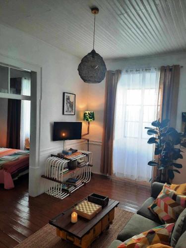 a living room with a couch and a table at Casa Malva - Traditional townhouse apartment in Monchique