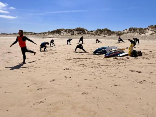 a group of people playing on the beach at Tiny House Eloá in Lourinhã