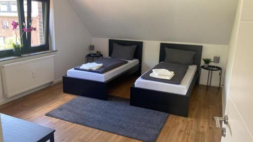 Giường trong phòng chung tại ND Hotels & Apartment Superior Bottrop