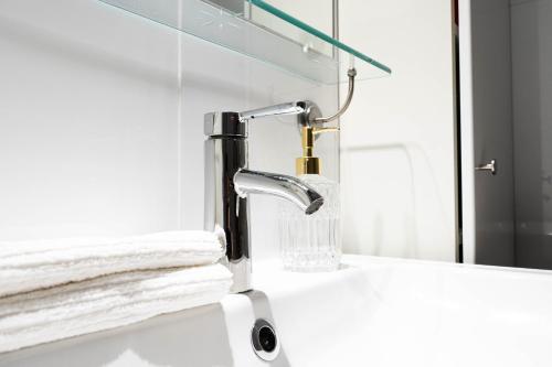 a bathroom sink with a faucet and a mirror at Royal Residence Schönbrunn in Vienna