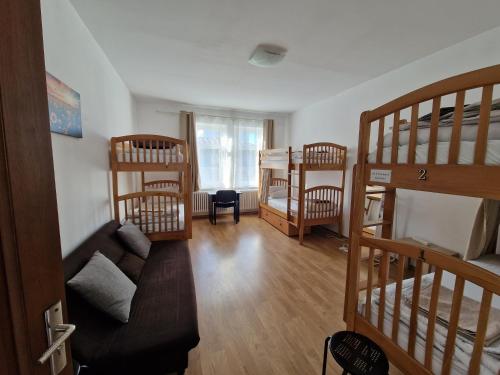 a living room with three bunk beds and a couch at Hostel Andrei in Iaşi