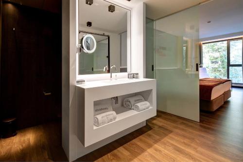 a bathroom with a sink and a mirror at Olivia Balmes Hotel in Barcelona