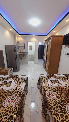 a hotel room with two beds and a bathroom at One rela state in 6th Of October