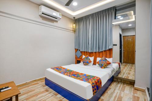 a bedroom with a large bed in a room at FabHotel Royal Orbits in Surat