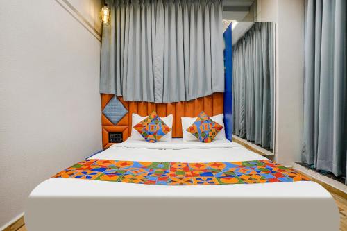 a bedroom with a bed with a colorful headboard at FabHotel Royal Orbits in Surat