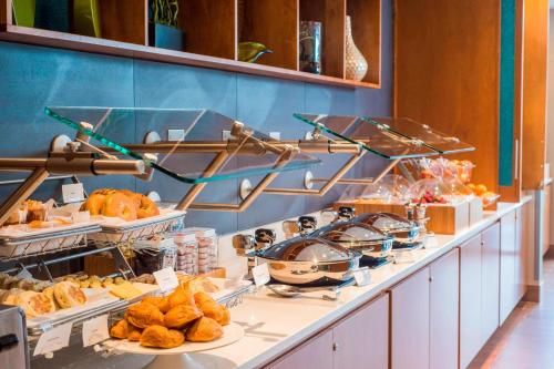 a buffet line with different types of pastries and bread at SpringHill Suites by Marriott Wisconsin Dells in Wisconsin Dells