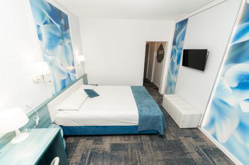 a room with a bed and a mirror at MyContinental Suceava in Suceava