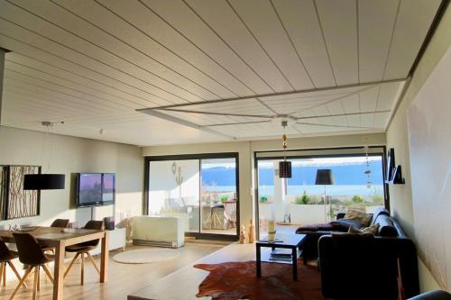 a living room with a couch and a table at SeaSide in Sipplingen
