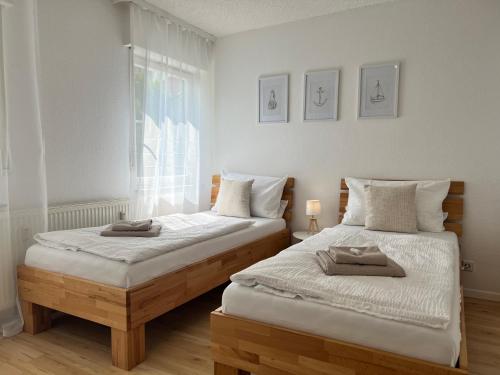 two beds sitting next to each other in a bedroom at Seeblick in Sipplingen in Sipplingen