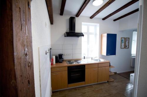 a kitchen with a sink and a stove top oven at NEU! FeWo Winkeleck in Alsfeld