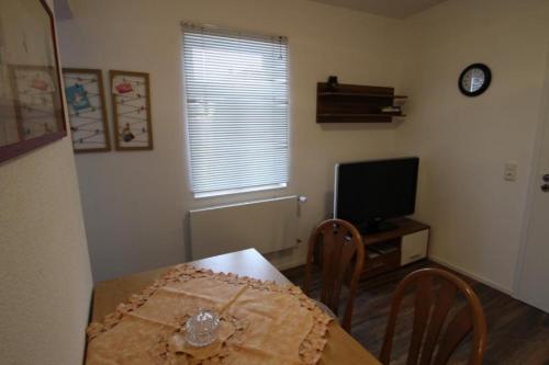 a dining room with a table and a television at NEU! FeWo Winkeleck in Alsfeld