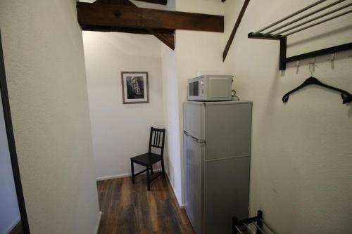 a room with a refrigerator with a microwave on top of it at NEU! FeWo Winkeleck in Alsfeld
