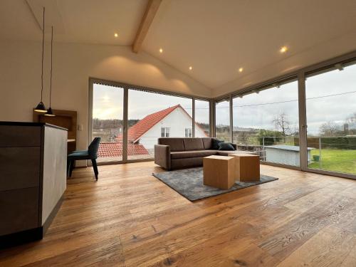 a living room with a couch and a table at Landhaus zum See - Fewo Eiche in Überlingen
