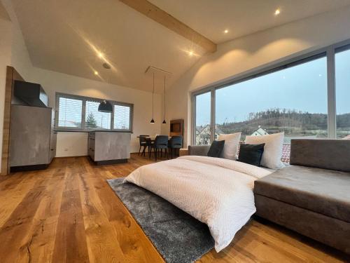 a bedroom with a bed and a large window at Landhaus zum See - Fewo Eiche in Überlingen